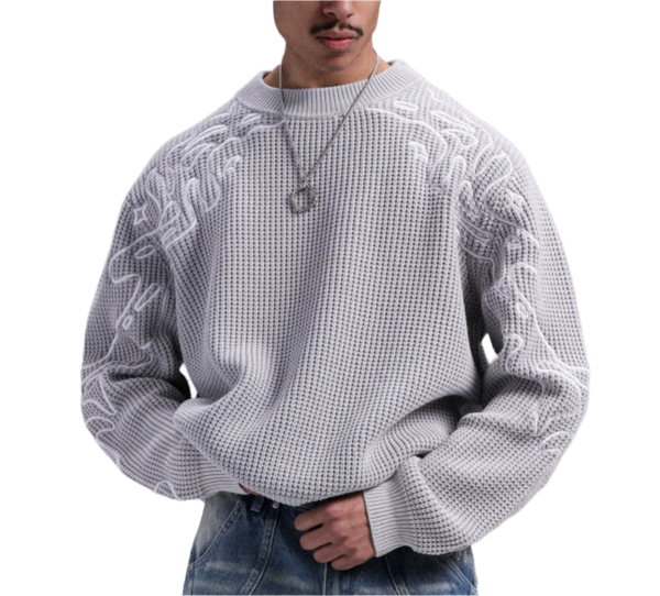 Person wearing a textured white sweater against a gray background