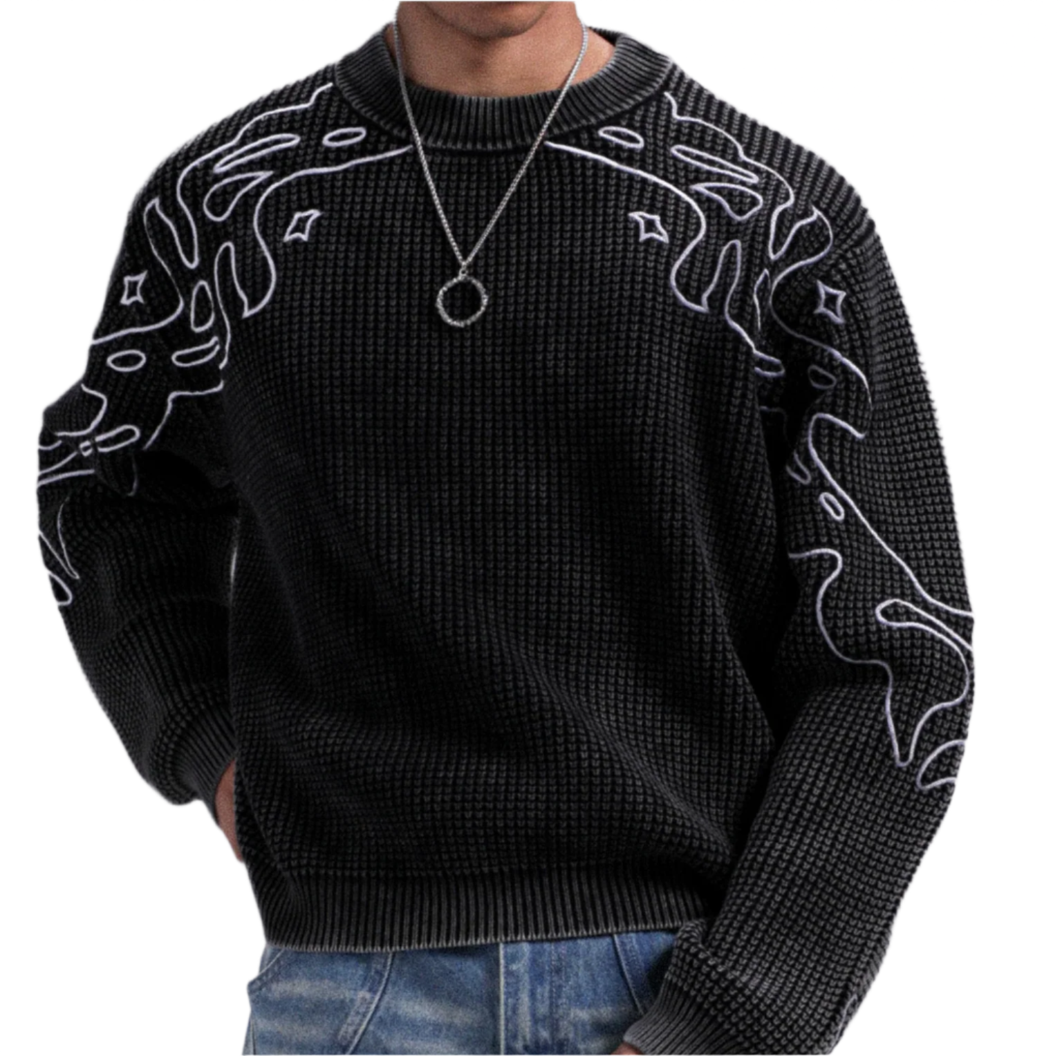 Black sweater with white patterns worn by a person on a gray background
