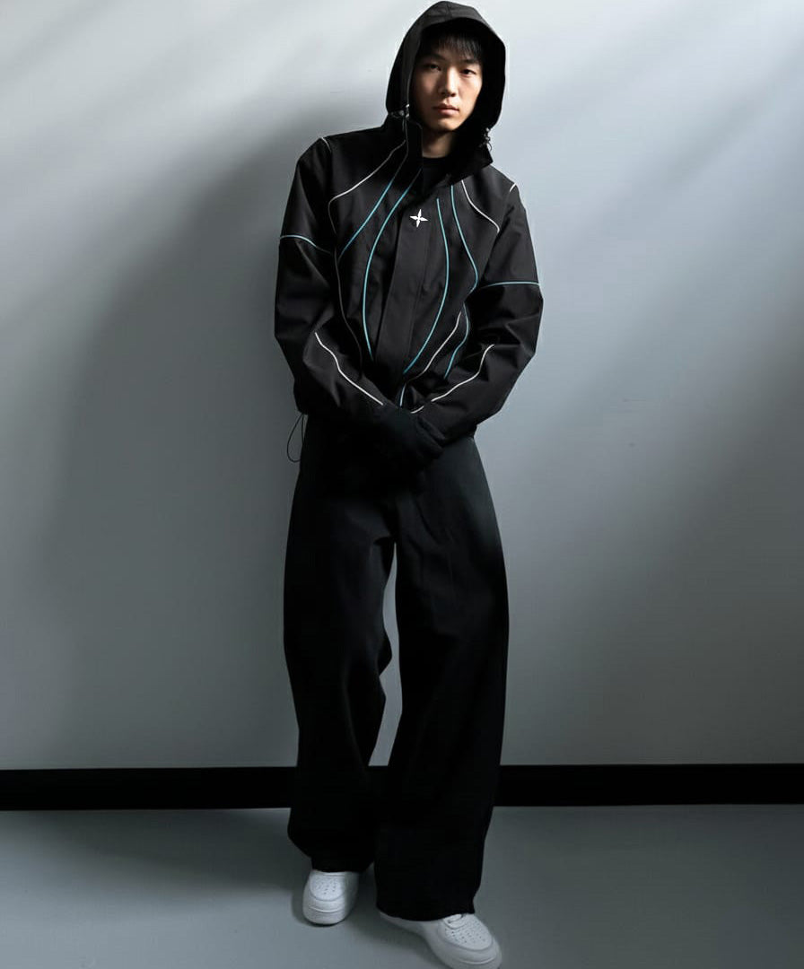 Person wearing a black hoodie and pants with a white cross symbol on a gray background
