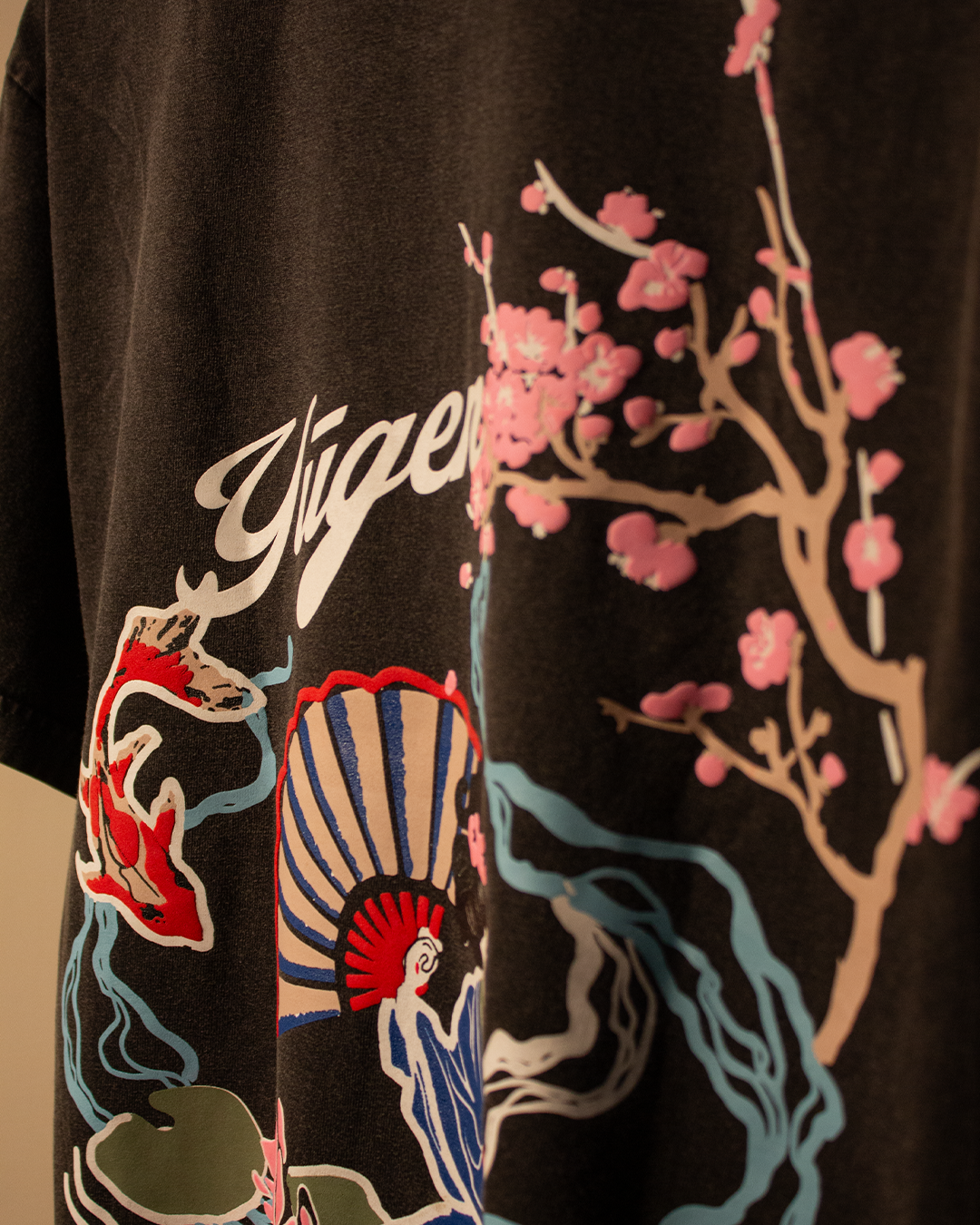 NVRFLD artistic tee with unique design featuring colorful floral and abstract patterns on black fabric