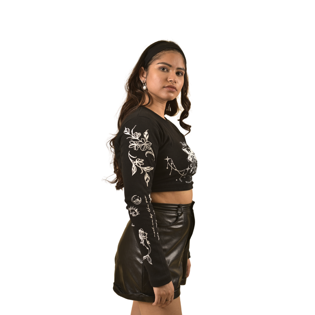 NVRFLD black club top with white floral designs on sleeves and front, worn with black leather skirt