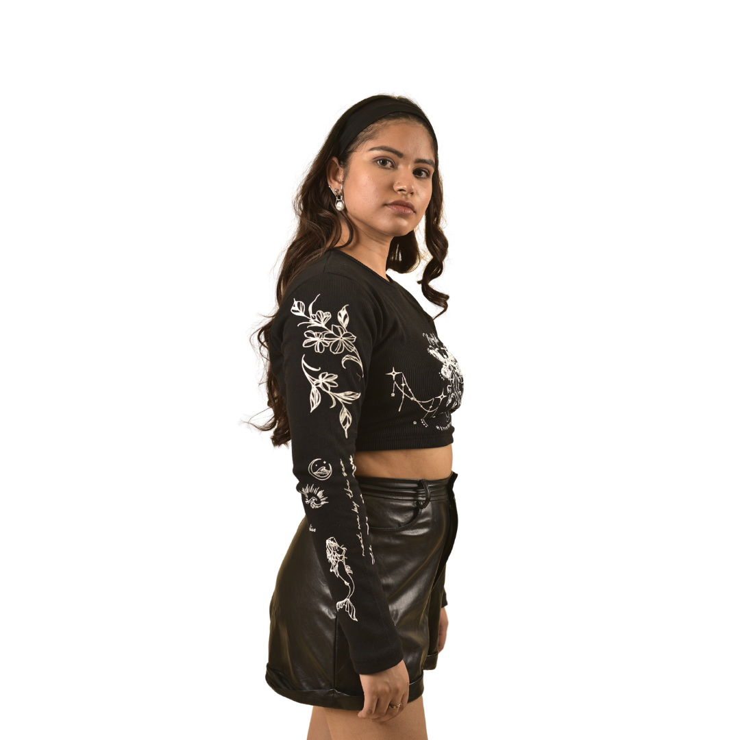 NVRFLD black club top with white floral designs on sleeves and front, worn with black leather skirt