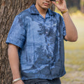 NVRFLD blue short sleeve contemporary statement shirt with nature print worn by man outdoors