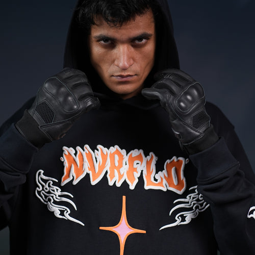 NVRFLD black graphic hoodie with orange and white logo worn by man with black gloves