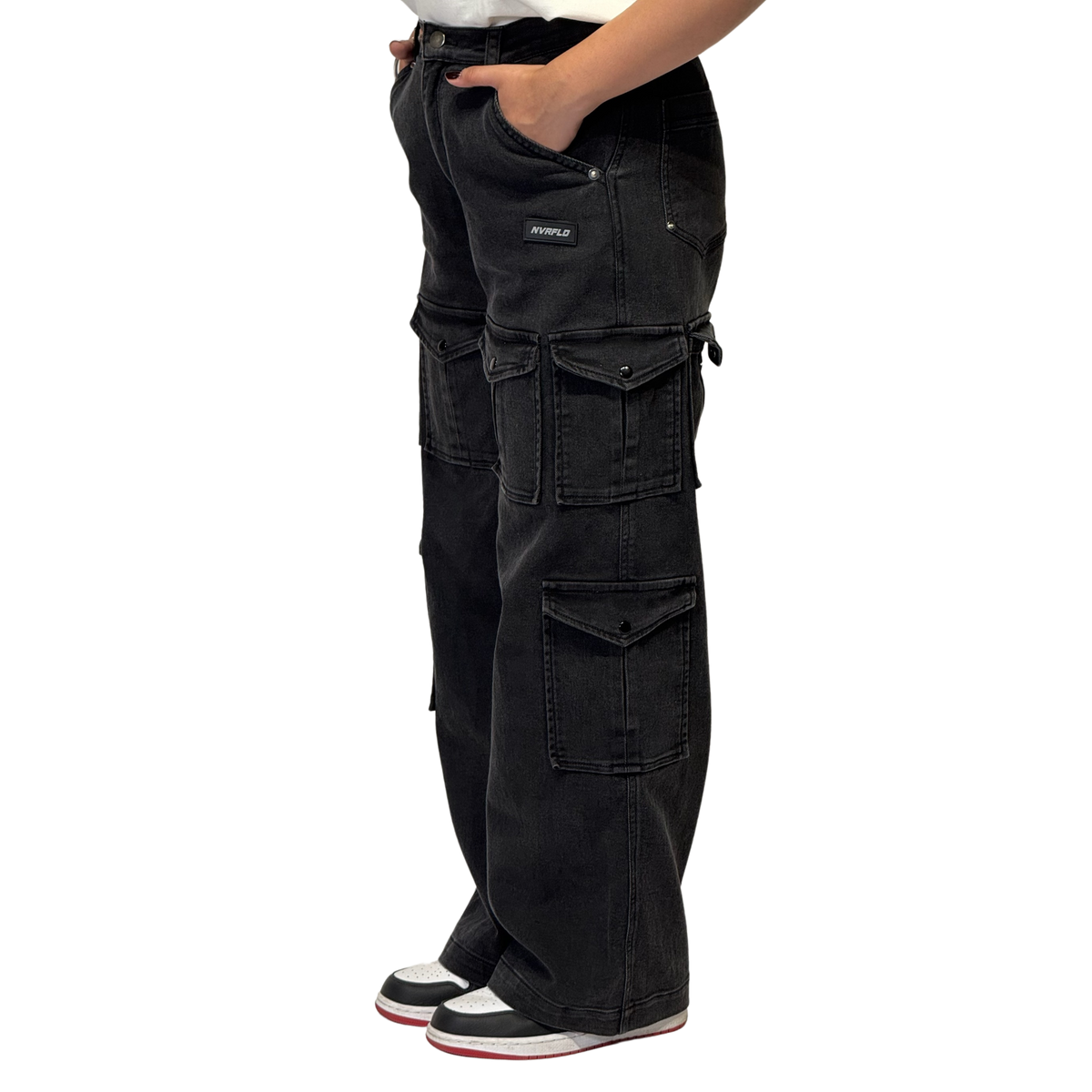 NVRFLD black utility cargo pants with multiple pockets and relaxed fit worn with sneakers